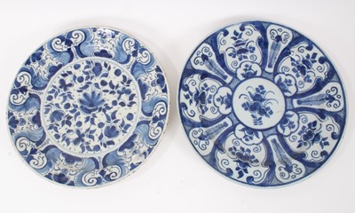Lot 192 - Two 18th century Dutch Delft blue and white circular dishes with foliate panels, 34cm and 35cm diameter