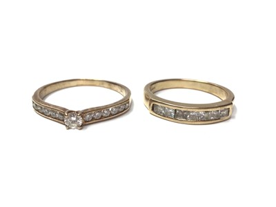 Lot 25 - 9ct gold diamond single stone ring with diamond set shoulders and 9ct gold synthetic white stone half eternity ring (2)