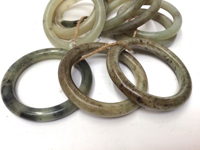 Lot 37 - Ten green jade/ hard stone polished bangles