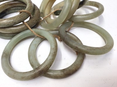 Lot 37 - Ten green jade/ hard stone polished bangles