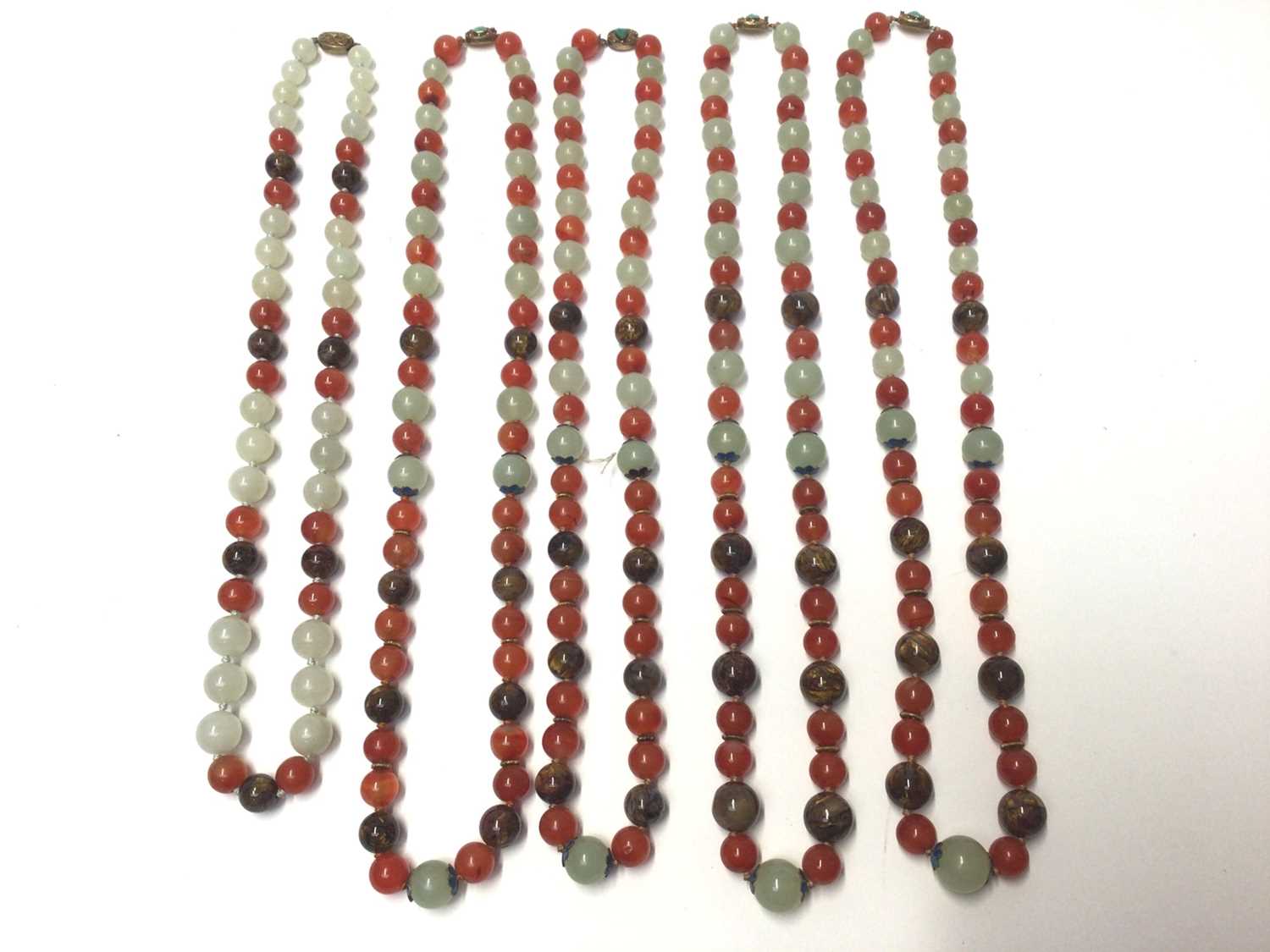 Lot 38 - Five Chinese green hard stone and carnelian polished bead necklaces