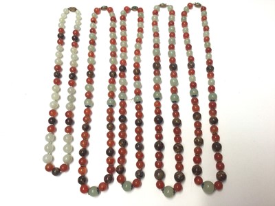 Lot 38 - Five Chinese green hard stone and carnelian polished bead necklaces