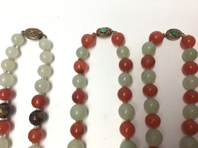 Lot 38 - Five Chinese green hard stone and carnelian polished bead necklaces