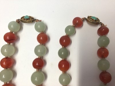 Lot 38 - Five Chinese green hard stone and carnelian polished bead necklaces