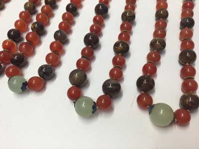 Lot 38 - Five Chinese green hard stone and carnelian polished bead necklaces