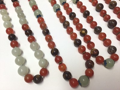 Lot 38 - Five Chinese green hard stone and carnelian polished bead necklaces