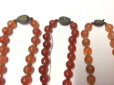 Lot 39 - Five Chinese carnelian polished bead necklaces