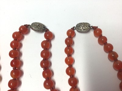Lot 39 - Five Chinese carnelian polished bead necklaces