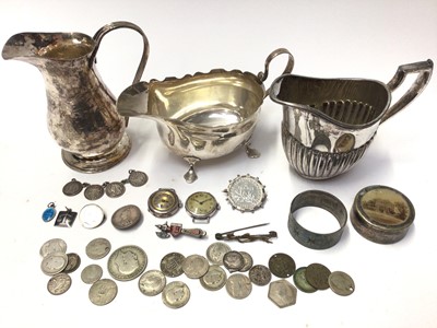 Lot 148 - Silver sauce boat, Arts & Crafts white metal milk jug, two silver cased watches, silver mounted coin brooch, other coins and plated items