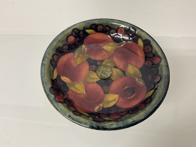 Lot 1039 - Moorcroft pottery tazza decorated in the pomegranate pattern on blue and green ground, on Tudric pewter base, impressed marks and blue painted signature, 13cm high, 19cm diameter