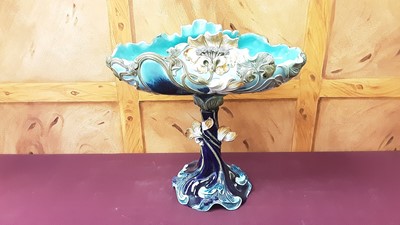 Lot 1277 - Art Nouveau majolica table centre / comport, shell-form top, decorated with sinuous floral motifs on a blue ground, marked to base, Wilhelm Schiller & Son, 42cm high