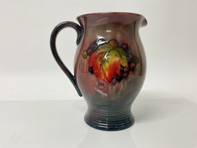 Lot 1105 - Moorcroft pottery Flambe jug decorated in the leaf and berry pattern, impressed marks and blue painted signature to base, 20.5cm high