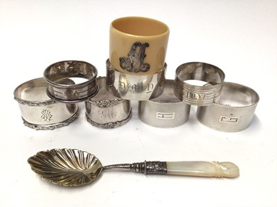 Lot 131 - Seven various silver napkin rings, celluloid napkin ring and silver spoon in fitted case