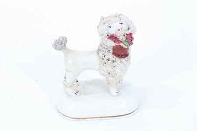 Lot 516 - Staffordshire porcelain model of a poodle carrying a basket, circa 1840