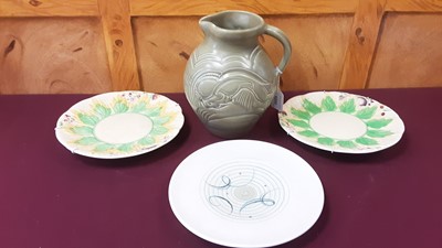 Lot 1233 - Susie Cooper 'Leaping Deer' pattern jug, 21cm high, together with a Susie Cooper plate and two Clarice Cliff plates (4)
