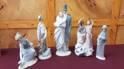Lot 1231 - Four Lladro porcelain figures, together with a Nao figure group (5)