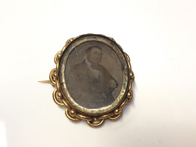 Lot 311 - Victorian portrait brooch in gilt metal mount containing a daguerreotype portrait of a gentleman