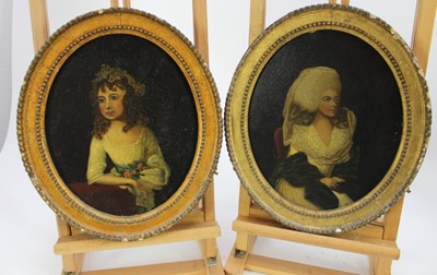 Lot 1104 - English School 18th Century, oil on 
canvas, a pair of oval portraits of ladies, one with flowers in her hair, in period gilt frames. Each 28 x 22cm.  (2)