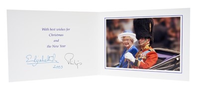 Lot 15 - H.M. Queen Elizabeth II and H.R.H. The Duke of Edinburgh, signed 2003 Christmas card with twin gilt Royal ciphers to cover, colour photograph of the Royal couple riding in an open carriage to the i...