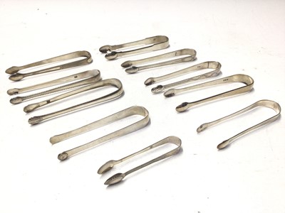 Lot 328 - Ten pairs of George III silver sugar tongs, most with bright cut engraved decoration, various dates and makers, mostly circa 1800, all at approximately 10oz, (10)