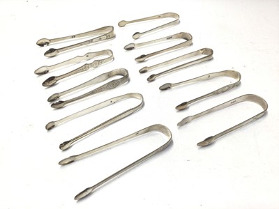 Lot 329 - Ten pairs of George III silver sugar tongs, most with bright cut engraved decoration, various dates and makers, mostly circa 1800, all at approximately 10oz, (10)