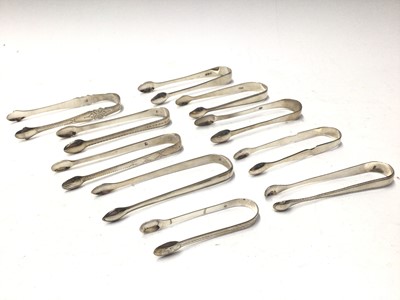 Lot 330 - Ten pairs of George III silver sugar tongs, most with bright cut engraved decoration, various dates and makers, mostly circa 1800, all at approximately 10oz, (10)