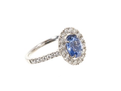 Lot 578 - Sapphire and diamond cluster ring with a cushion cut unheated Burmese blue sapphire weighing 2.02cts surrounded by a 'halo' mount of brilliant cut diamonds with further diamonds to the shoulder...