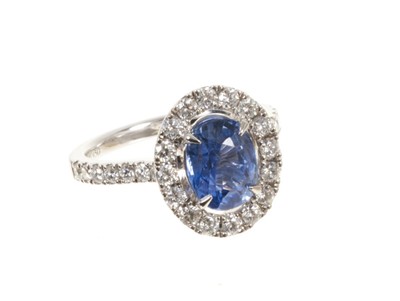 Lot 578 - Sapphire and diamond cluster ring with a cushion cut unheated Burmese blue sapphire weighing 2.02cts surrounded by a 'halo' mount of brilliant cut diamonds with further diamonds to the shoulder...