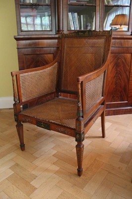 Lot 1204 - Edwardian neoclassical revival painted satinwood bergere library chair with polychrome painted neo-classical reserves and floral festoons and husks on square taper legs terminating on spade feet