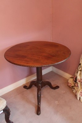 Lot 1218 - George III mahogany tripod table with tilt top on birdcage mechanism, cannon barrel column and three hipped splayed legs with later carving terminating on pad feet