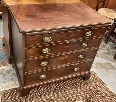 Lot 1224 - George III mahogany chest of drawers with brushing slide and four long graduated drawers with oval brass handles and cock beaded edge on bracket feet, 86cm wide.