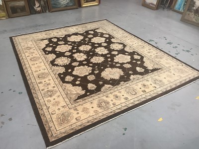 Lot 1225 - Afghan carpet wool pile carpet with floral design on brown and cream ground, 307cm x 278cm