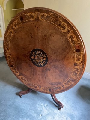 Lot 1229 - Good Victorian figured walnut and floral marquetry inlaid circular dining table, circular tilt top centred by inlaid roundel on facetted column and tripod base on castors, 131cm diameter