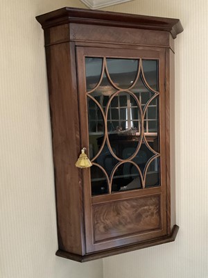 Lot 1232 - George III mahogany and boxwood line inlaid corner cupboard, enclosed by an astragal glazed door, 68cm wide x 41cm deep x 108cm high