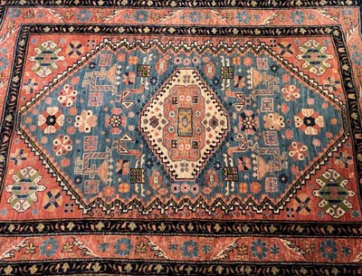 Lot 1236 - Two Persian design rugs, the first with radiating medallion on sky blue ground, signature panel, tassel ends, 158 x 111cm, the other with central conjoined medallion and scattered animal motifs on...