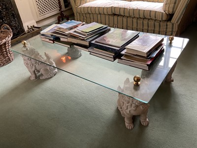 Lot 1244 - Decorative glass coffee table, with rectangular top on dog of foo ceramic supports