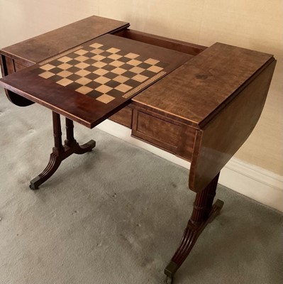 Lot 1246 - Regency style mahogany sofa / games table, the hinged rounded rectangular top with reversible top having chess board inlay to one face and reservoir below, raised on dual fluted end supports and sp...