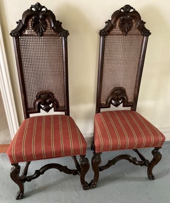 Lot 1256 - Pair of William and Mary style walnut and caned high back side chairs, each with shell cresting and stuffover seat on squared legs and paw feet, early elements