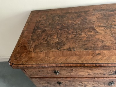 Lot 1257 - Impressive early 18th century Italian figured walnut crossbanded and marquetry inlaid commode, the top with shaped angles, over four drawers, each with early paper lining, on tapered feet, a note i...