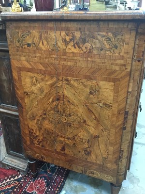 Lot 1257 - Impressive early 18th century Italian figured walnut crossbanded and marquetry inlaid commode, the top with shaped angles, over four drawers, each with early paper lining, on tapered feet, a note i...