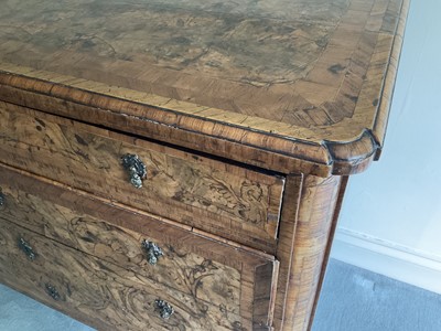 Lot 1257 - Impressive early 18th century Italian figured walnut crossbanded and marquetry inlaid commode, the top with shaped angles, over four drawers, each with early paper lining, on tapered feet, a note i...
