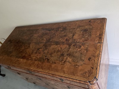 Lot 1257 - Impressive early 18th century Italian figured walnut crossbanded and marquetry inlaid commode, the top with shaped angles, over four drawers, each with early paper lining, on tapered feet, a note i...