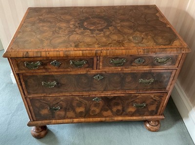 Lot 1259 - Rare William and Mary laburnum oyster veneered chest of drawers, with concentric veneered top and two short over two long drawers raised on later bun feet, probably formerly a chest on stand. 91cm...