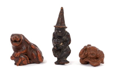 Lot 843 - Three Japanese carved wooden netsuke
