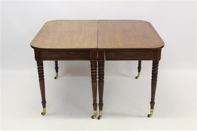 Lot 1282 - Good Regency figured mahogany extending dining table, with D-ends raised on ringed turned legs and brass cappings and castors, with two additional leaves, 98cm wide x 120cm long extending to 250cm...