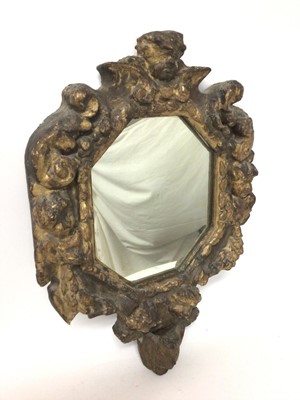 Lot 1309 - Continental Baroque carved giltwood wall mirror, with octagonal plate within heavy mask and scroll carved frame, probably 18th century, 59 x 40cm