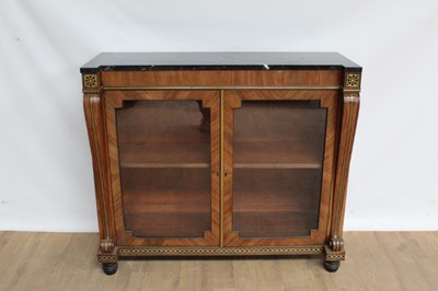 Lot 1376 - Early 19th century marble topped brass inlaid pier cabinet, enclosed by pair of glazed doors between flanking projecting scrolling stiles, raised on spool feet, 105cm wide x 38cm deep x 91cm high