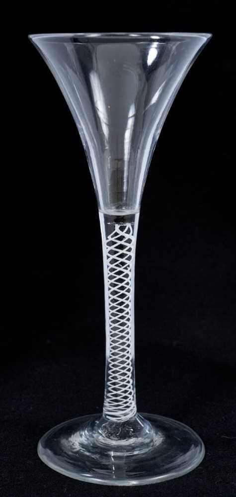 Lot 271 - Georgian toasting glass of tall slender form with trumpet bowl, opaque twist stem on splayed foot 18cm