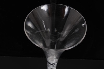 Lot 271 - Georgian toasting glass of tall slender form with trumpet bowl, opaque twist stem on splayed foot 18cm