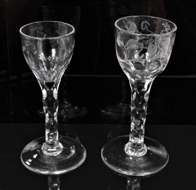 Lot 277 - Two Georgian wine glasses with floral and swag cut bowls on faceted stems on splayed foot 13.5-14 cm (2)